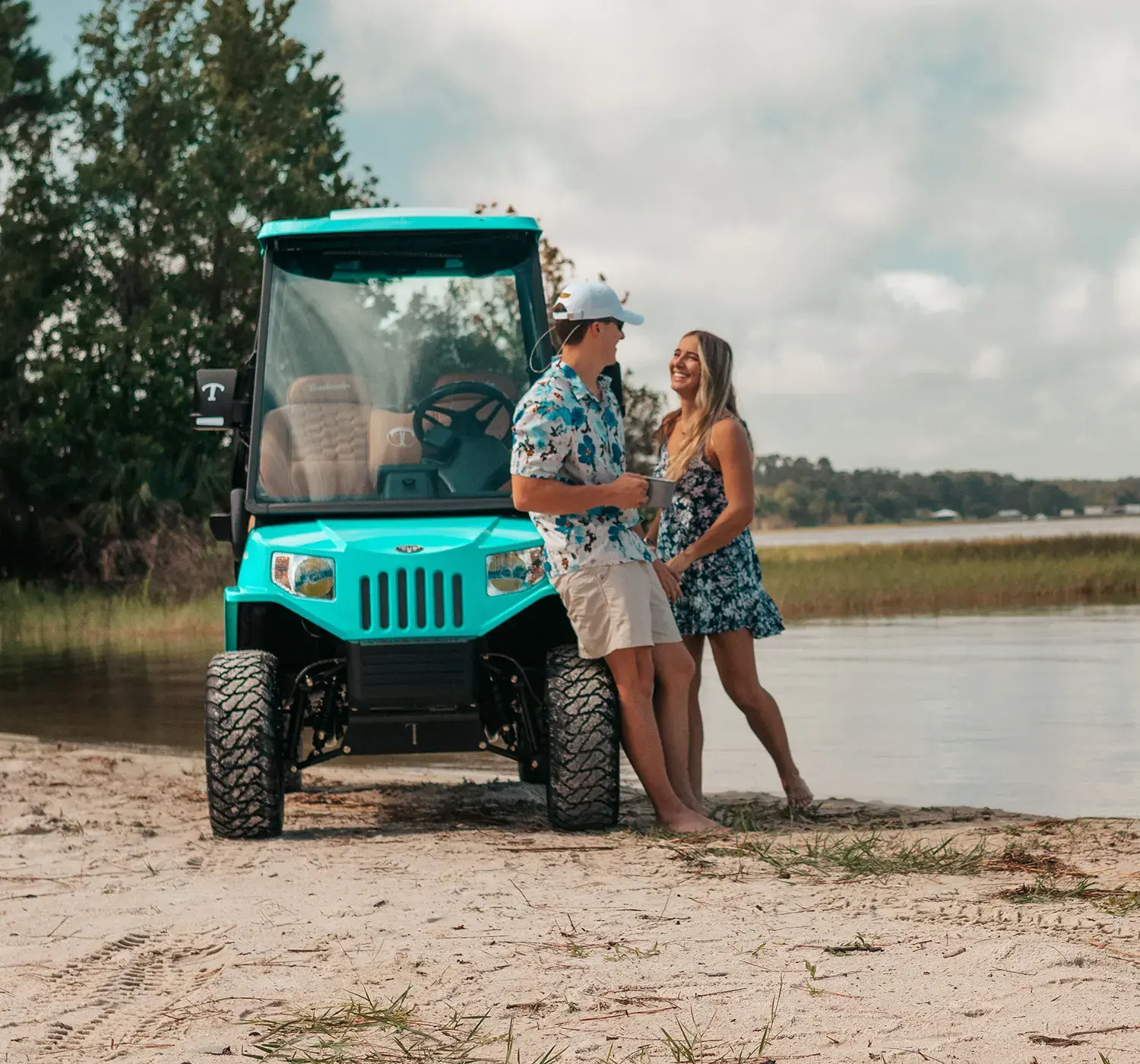 couple with tomberlin vehicle at the beach